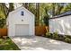 Detached garage with white siding, concrete driveway, and well-maintained landscaping at 1481 Almont Sw Dr, Atlanta, GA 30310