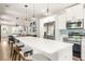 Open floor plan with kitchen island with quartz countertop and barstool seating at 1481 Almont Sw Dr, Atlanta, GA 30310