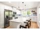 Bright kitchen featuring white cabinets, stainless steel appliances, and large island with seating at 1481 Almont Sw Dr, Atlanta, GA 30310