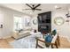 Bright living room featuring modern decor, fireplace, and large windows at 1481 Almont Sw Dr, Atlanta, GA 30310
