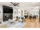 Bright living room open to dining area, featuring modern decor, fireplace, and large windows at 1481 Almont Sw Dr, Atlanta, GA 30310