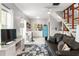 Cozy living area with a blue retro-style fridge, kitchen area and an open staircase at 1481 Almont Sw Dr, Atlanta, GA 30310