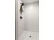Contemporary shower featuring white vertical tiling, hexagon floor tile, and a modern shower head at 1481 Almont Sw Dr, Atlanta, GA 30310