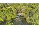 Aerial view of two-story traditional home nestled among mature trees on large lot at 1488 Rivermist Sw Dr, Lilburn, GA 30047