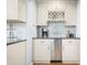 A small bar area features white cabinets, a wine rack, and a beverage cooler at 1488 Rivermist Sw Dr, Lilburn, GA 30047