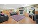 Finished basement with a stone fireplace, plush seating, and a large area rug at 1488 Rivermist Sw Dr, Lilburn, GA 30047