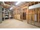 Unfinished basement with exposed ceiling, framing and storage shelving at 1488 Rivermist Sw Dr, Lilburn, GA 30047