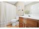 Bathroom featuring a wood vanity, a toilet, and a shower with a decorative curtain at 1488 Rivermist Sw Dr, Lilburn, GA 30047