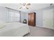 Cozy bedroom with natural light from the window and a classic wooden wardrobe at 1488 Rivermist Sw Dr, Lilburn, GA 30047