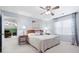 Comfortable bedroom with neutral walls, a large window, and a glimpse into an adjacent room at 1488 Rivermist Sw Dr, Lilburn, GA 30047