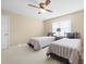 Bright bedroom featuring two twin beds, a ceiling fan, and a window with blinds at 1488 Rivermist Sw Dr, Lilburn, GA 30047