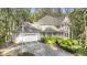 Traditional two story home with attached garage, balcony and mature landscaping at 1488 Rivermist Sw Dr, Lilburn, GA 30047