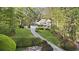 Traditional two story home with landscaped driveway and an American flag at 1488 Rivermist Sw Dr, Lilburn, GA 30047