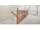 Hallway with a carpeted staircase and a view towards the front door at 1488 Rivermist Sw Dr, Lilburn, GA 30047
