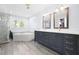 Luxurious main bathroom with double vanity, soaking tub, and a separate glass-enclosed shower at 1488 Rivermist Sw Dr, Lilburn, GA 30047