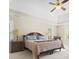 Bright main bedroom featuring tray ceiling, fan, and ample natural light from surrounding windows at 1488 Rivermist Sw Dr, Lilburn, GA 30047