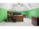 Bright home office featuring dual monitors, a skylight and green accent walls at 1488 Rivermist Sw Dr, Lilburn, GA 30047