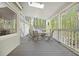Covered porch with outdoor seating and a view of the wooded backyard at 1488 Rivermist Sw Dr, Lilburn, GA 30047