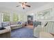 Inviting sunroom with comfortable seating, a ceiling fan, and ample natural light at 1488 Rivermist Sw Dr, Lilburn, GA 30047