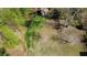 A large backyard with a shed and an outdoor fire pit surrounded by trees, perfect for outdoor entertaining at 158 Grove Meadow Dr, Acworth, GA 30101