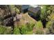 Aerial view of a private backyard featuring mature trees, lawn, and patio at 158 Grove Meadow Dr, Acworth, GA 30101