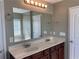 Bright bathroom featuring double sinks, marble countertop, and large mirror at 158 Grove Meadow Dr, Acworth, GA 30101