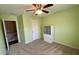Bedroom featuring storage cabinet, a ceiling fan, carpet and a window, with hallway access at 158 Grove Meadow Dr, Acworth, GA 30101