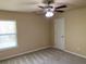 Bedroom with neutral carpet, featuring a window and a ceiling fan for comfort and style at 158 Grove Meadow Dr, Acworth, GA 30101