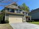 Side view of a two-story home featuring a well-kept lawn, and an attached two-car garage at 158 Grove Meadow Dr, Acworth, GA 30101