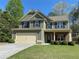 Charming two-story home featuring a two-car garage, stone accents and a well-manicured lawn at 158 Grove Meadow Dr, Acworth, GA 30101