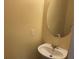 Small half bathroom featuring a pedestal sink and round mirror at 158 Grove Meadow Dr, Acworth, GA 30101
