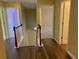 Hallway with hardwood floors, connecting multiple rooms of the house for easy navigation at 158 Grove Meadow Dr, Acworth, GA 30101