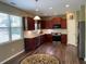 Well-lit kitchen featuring stainless steel appliances, granite countertops, and beautiful wood flooring at 158 Grove Meadow Dr, Acworth, GA 30101
