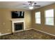 Bright living room featuring a stone fireplace, television, and plenty of natural light at 158 Grove Meadow Dr, Acworth, GA 30101