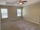 Large main bedroom with a trey ceiling, carpet, and natural light from two windows at 158 Grove Meadow Dr, Acworth, GA 30101