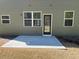 Exterior view showcasing a concrete patio with windows and a door at 158 Grove Meadow Dr, Acworth, GA 30101