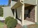 Cozy porch area showcasing stacked stone, an outdoor shade and manicured greenery at 158 Grove Meadow Dr, Acworth, GA 30101