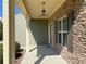 Inviting porch featuring stone accents, overhead lighting, and well-maintained landscaping at 158 Grove Meadow Dr, Acworth, GA 30101