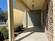 Exterior view of a cozy porch featuring overhead lighting, stacked stone and lush landscaping at 158 Grove Meadow Dr, Acworth, GA 30101
