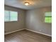 Bright bedroom featuring wood floors and two windows that bring in plenty of sunlight at 2858 Davidson Dr, Lithonia, GA 30058