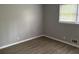 Neutral-toned bedroom featuring hard wood floors and a window bringing in natural light at 2858 Davidson Dr, Lithonia, GA 30058