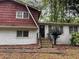 Inviting two-story house with a brick facade, complemented by a red-painted upper level at 2858 Davidson Dr, Lithonia, GA 30058