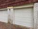 Attached two car garage featuring white doors and brick facade, providing convenient parking at 2858 Davidson Dr, Lithonia, GA 30058