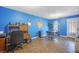 A large blue room with plenty of sunlight and space, complete with a work desk and chair at 31 Churchill Downs Ne, Cartersville, GA 30121