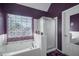 Bathroom featuring a soaking tub with jets, walk in shower, and purple walls at 31 Churchill Downs Ne, Cartersville, GA 30121