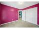Bedroom with carpet flooring, pink walls and a double-door closet at 31 Churchill Downs Ne, Cartersville, GA 30121