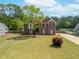 Charming brick two-story home with a beautifully landscaped front yard and long driveway at 31 Churchill Downs Ne, Cartersville, GA 30121