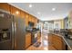 Functional kitchen with updated appliances, wooden cabinets, and view into breakfast nook at 31 Churchill Downs Ne, Cartersville, GA 30121