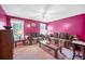 Inviting living room with large windows, comfortable sofas, plush carpet, and bright pink walls at 31 Churchill Downs Ne, Cartersville, GA 30121