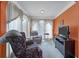 Cozy sitting area featuring comfortable armchairs, neutral carpet, and bright orange walls at 31 Churchill Downs Ne, Cartersville, GA 30121